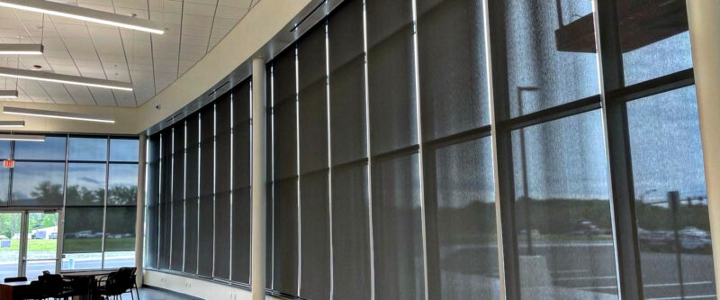 Wall of EcoSmart motorized roller / solar shades in commercial business